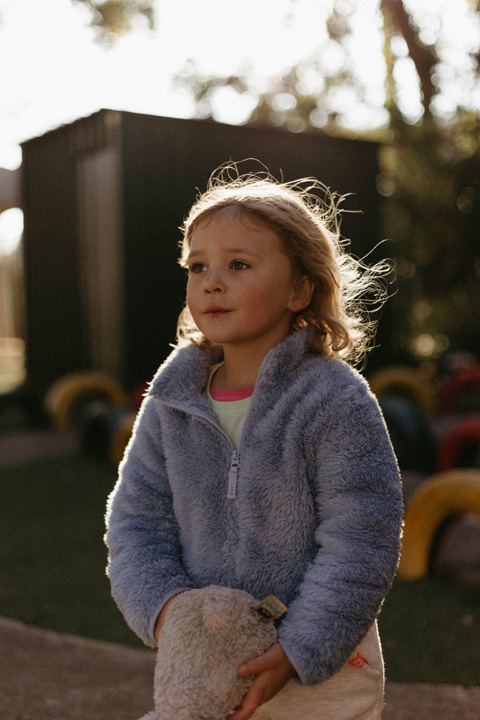 child in the sun, wind swept hair