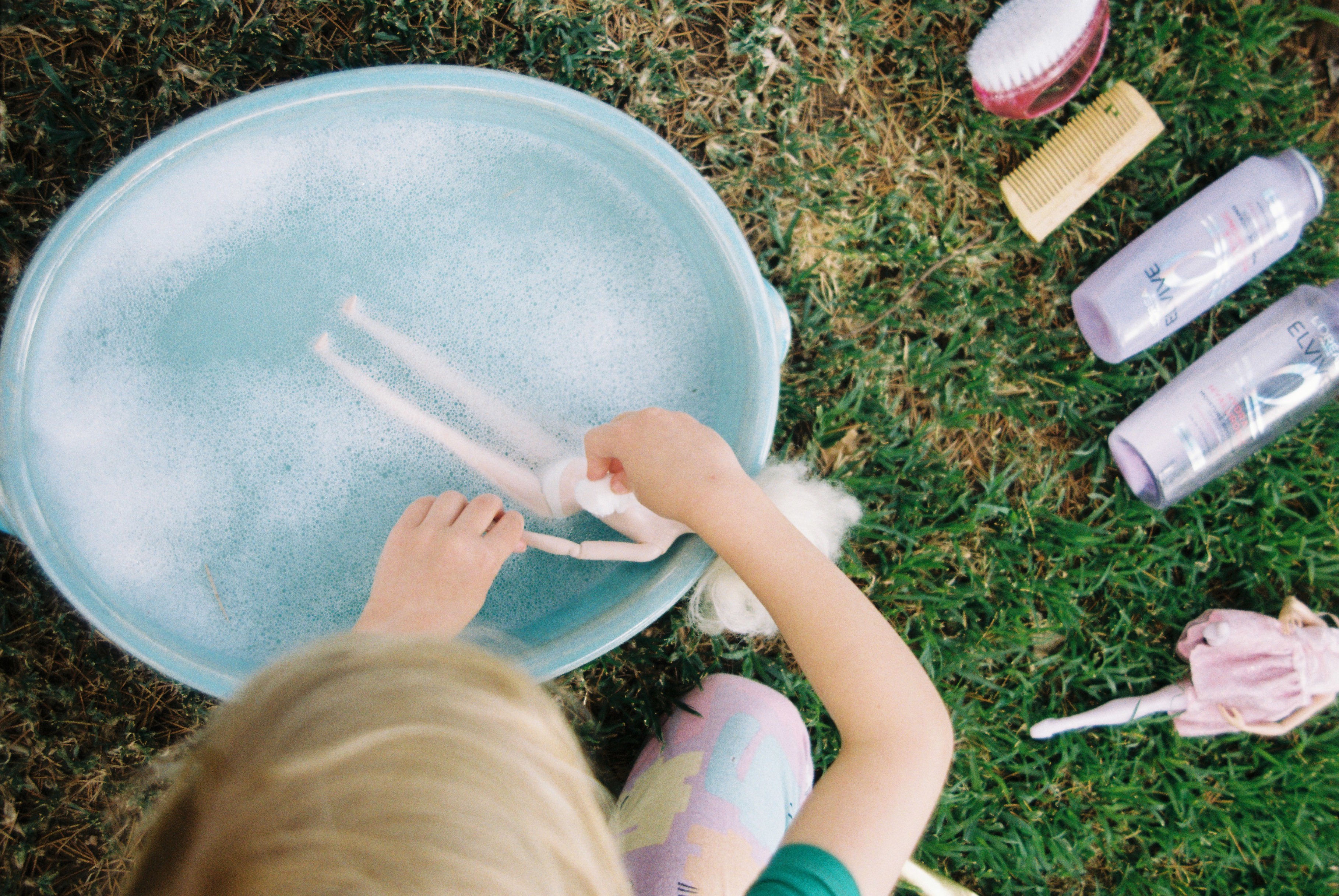 close up of girls washing barbie dolls