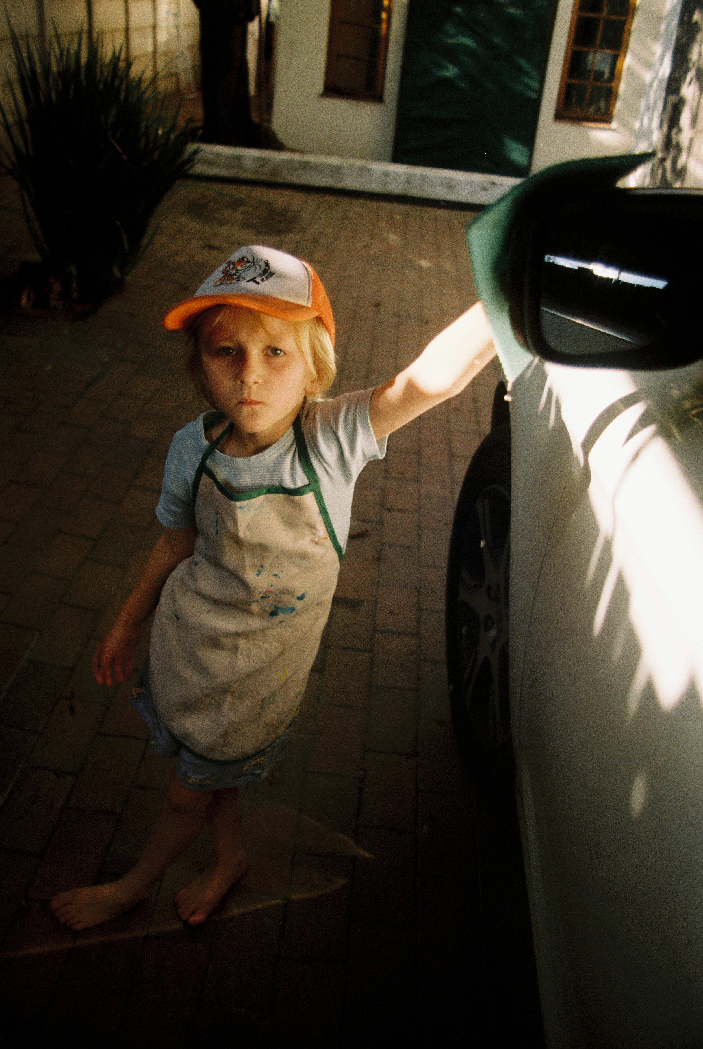portrait of child next to car