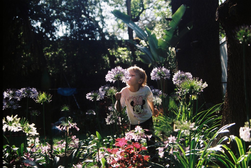 smelling flowers at family photoshoot