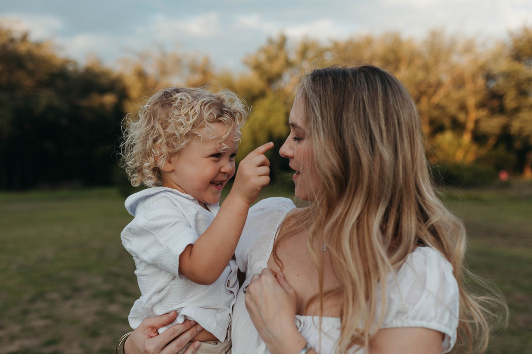 Natural light photograph of mum playing with toddlers during emotive family storytelling session Johannesburg
