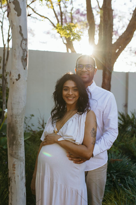 "Intimate maternity moment captured during seasonal jacaranda blooms natural light Pretoria photographer
