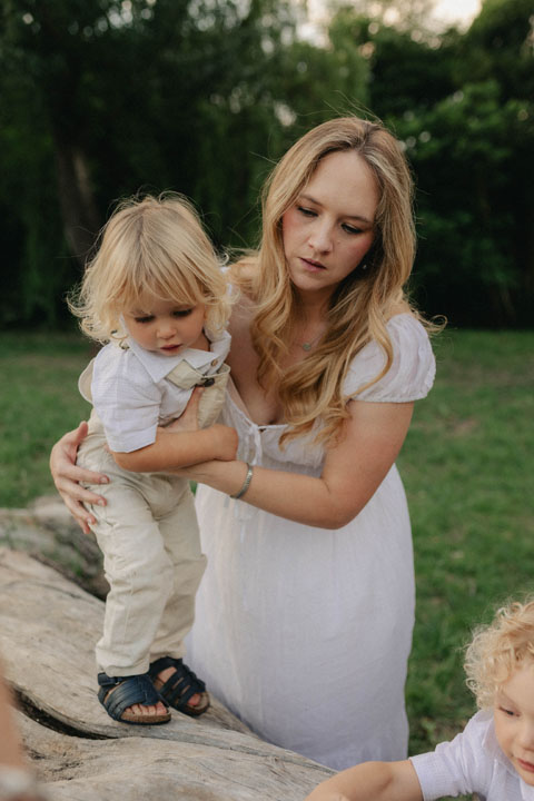 Mother playing with two toddlers in natural light during storytelling family session Gauteng photographer