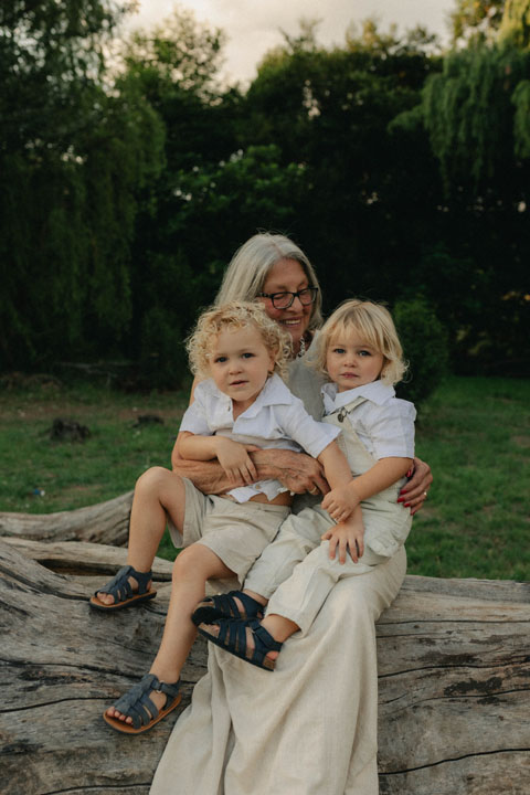 Storytelling photograph of grandmother in beautiful natural light emotive family photoshoot outdoors