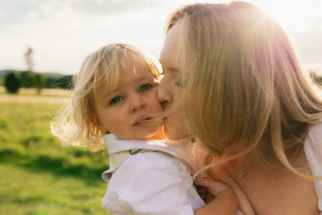 Natural light family photoshoot Johannesburg - candid moment between mother and young daughter at sunset