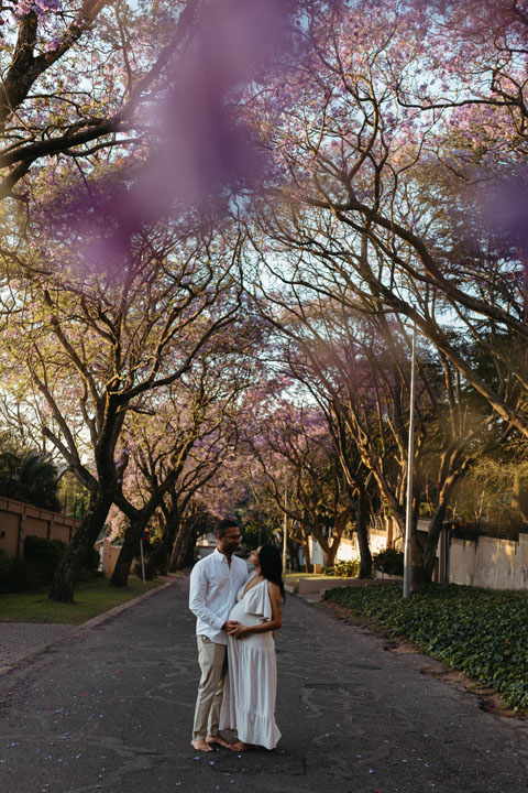 Storytelling maternity photograph during brief jacaranda bloom season Johannesburg family photographer