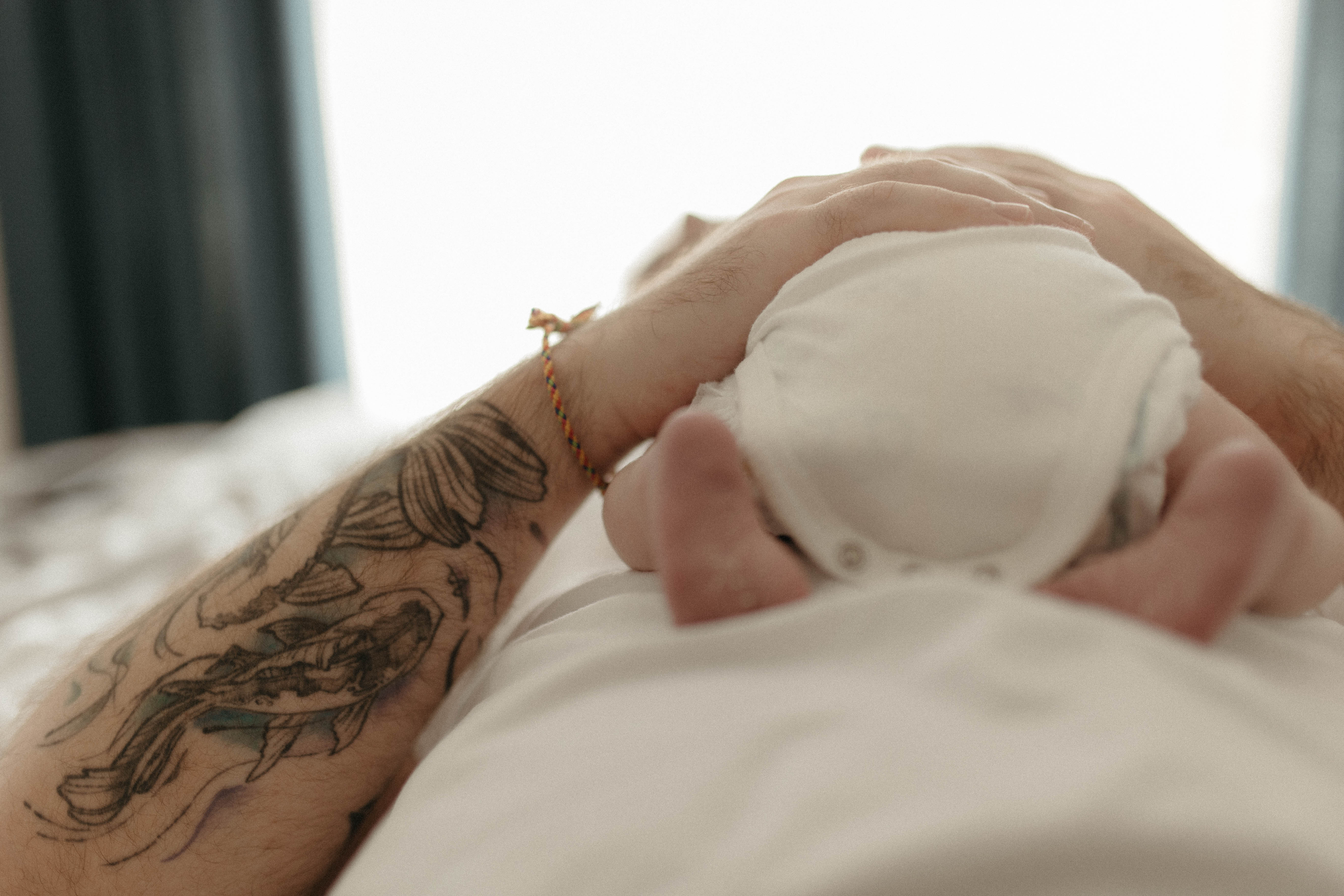 dad with tattoos and newborn in family photoshoot